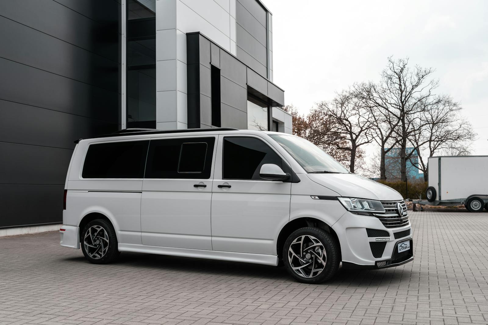 White Van Parked In Front of a Building